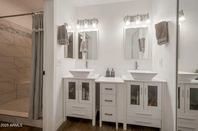 a view of bathroom with dual sinks