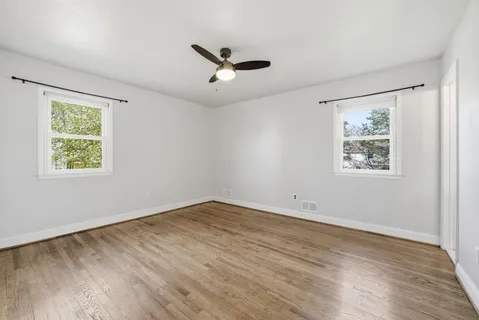 a view of an empty room with wooden floor