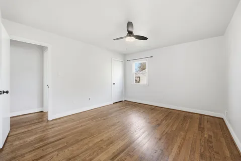 a view of wooden floor and windows in a room