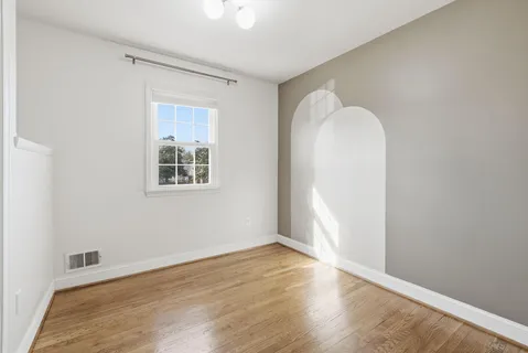 a view of a livingroom with a fireplace and a window