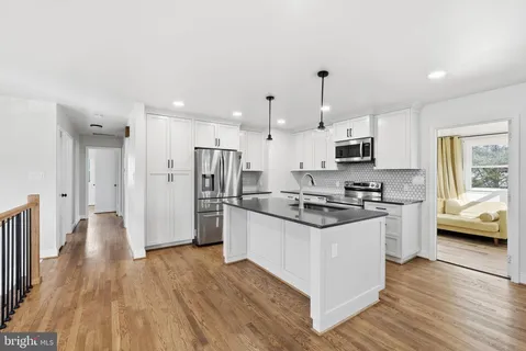 a kitchen with stainless steel appliances a stove a microwave sink and cabinets
