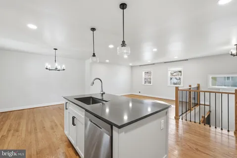 a view of kitchen with wooden floor and windows