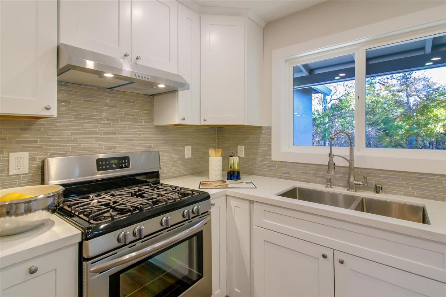 696 Coyote Road San Jose, CA 95111 - Photo 13 of 47 a kitchen with a stove a sink and a window