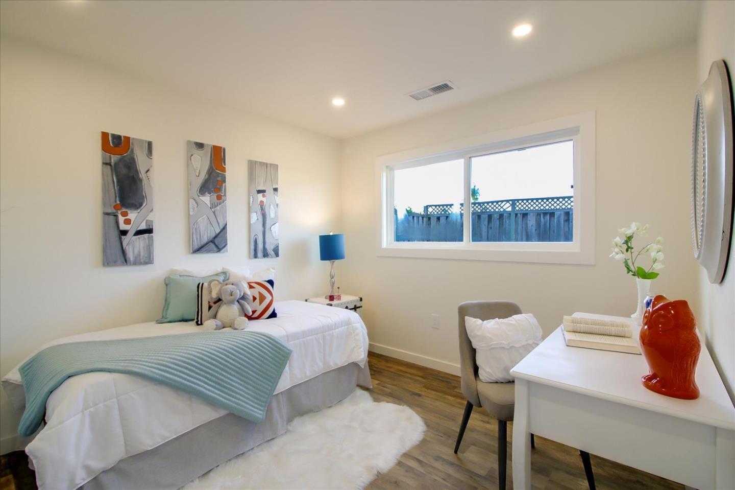 696 Coyote Road San Jose, CA 95111 - Photo 17 of 47 a bedroom with a bed and a table