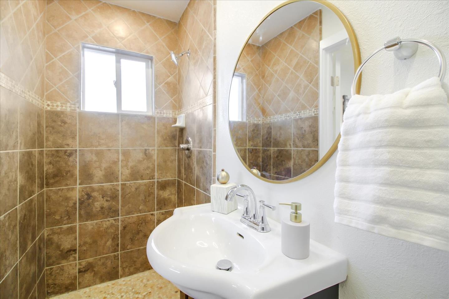 696 Coyote Road San Jose, CA 95111 - Photo 22 of 47 a bathroom with a sink a mirror and a shower