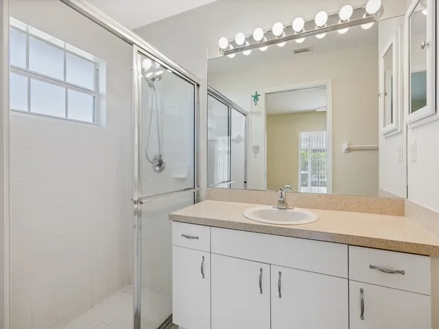 a bathroom with a sink double vanity and a mirror