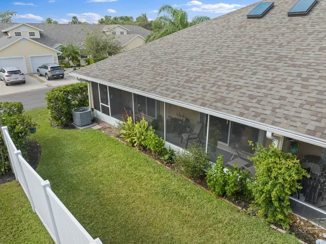 a house with green field in front of it