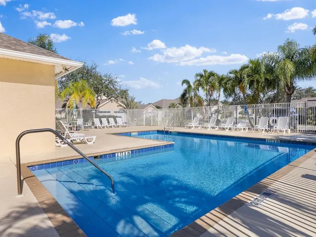 a view of a swimming pool with a table and chairs