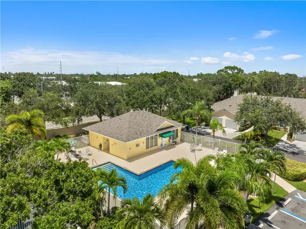 an aerial view of a house with green yard