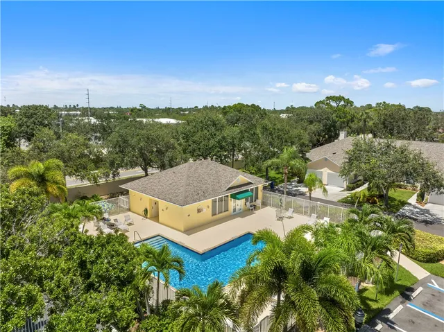 an aerial view of a house with green yard