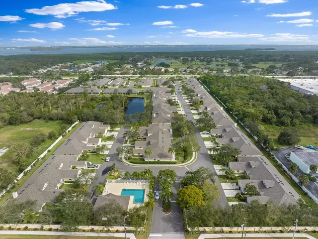 an aerial view of residential houses with outdoor space and street view