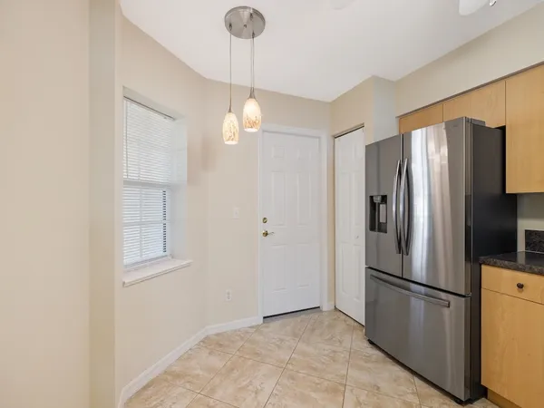 a metallic refrigerator freezer sitting in a kitchen