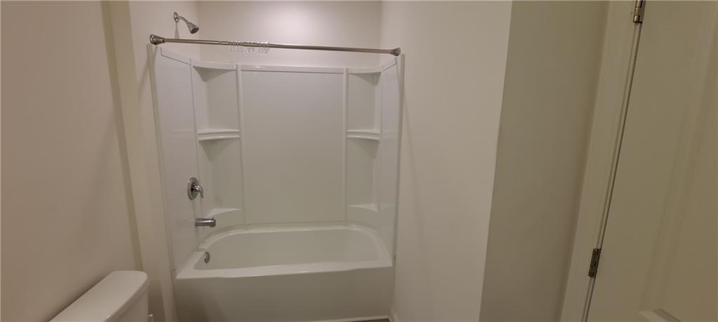 1683 Vernon Boulevard Decatur, GA 30035 - Photo 12 of 14 a bathroom with a shower and a bath tub