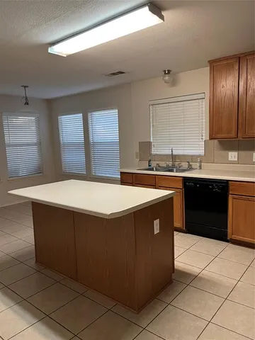 a kitchen with a sink and a stove top oven