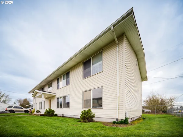 a view of house with yard and green space