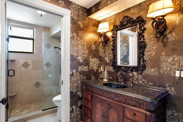 a bathroom with a sink toilet and shower