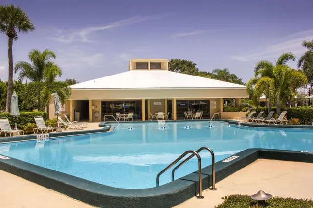 a front view of house and yard with swimming pool and patio