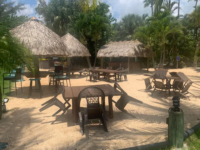 a view of a patio with a table chairs and a barbeque