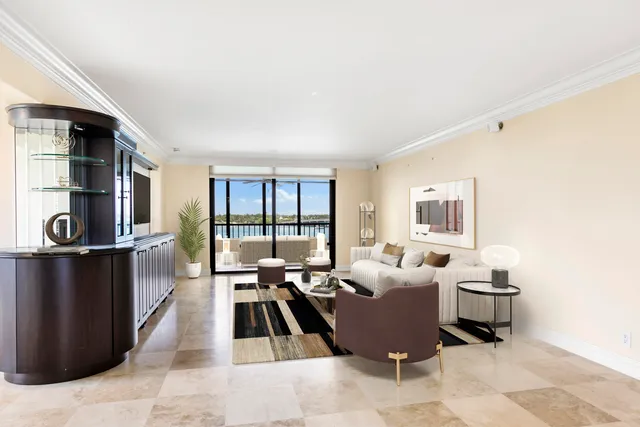 a living room with furniture and a floor to ceiling window