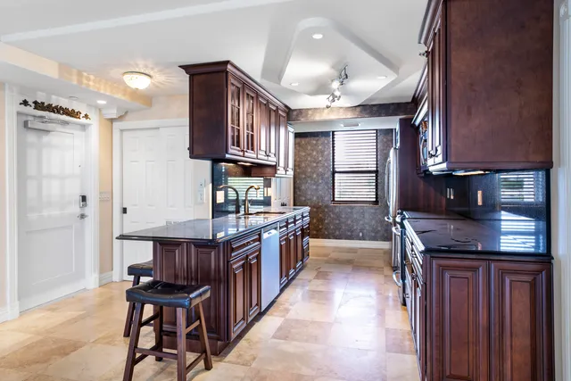 a kitchen with stainless steel appliances granite countertop a stove a sink dishwasher and cabinets