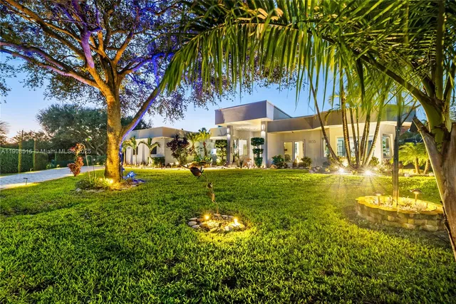 a view of yard with swimming pool and trees