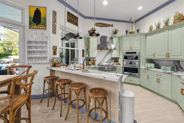 a kitchen with cabinets and chairs