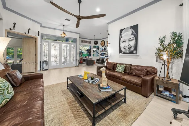 a living room with furniture and a wooden floor