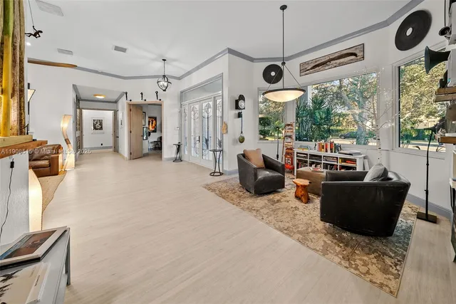a living room with furniture a flat screen tv and a large window