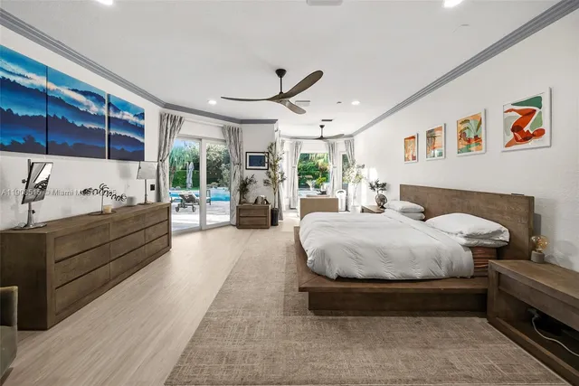 a spacious bedroom with a bed a couch and large window