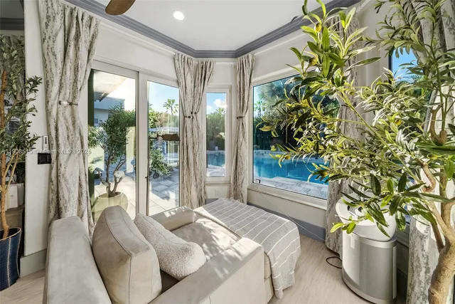 a bedroom with a bed and a potted plant