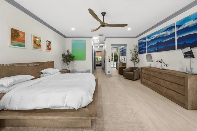 a bedroom with a bed mirror and window