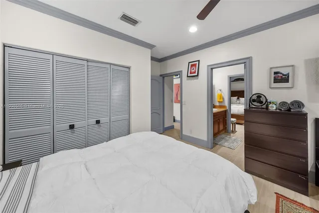 a en suite bathroom with a granite countertop sink and a mirror