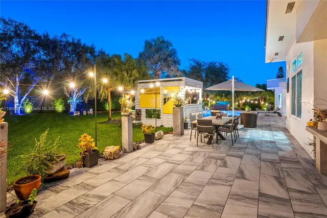 a view of a patio with swimming pool table and chairs