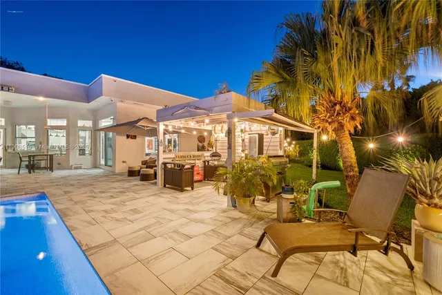 a view of a dining room with furniture a chandelier and wooden floor