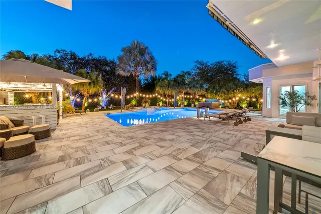 a view of swimming pool with outdoor seating and yard