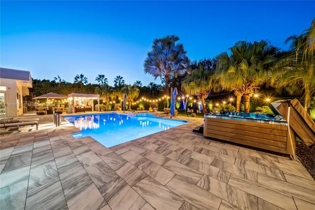 an aerial view of residential houses with outdoor space and swimming pool