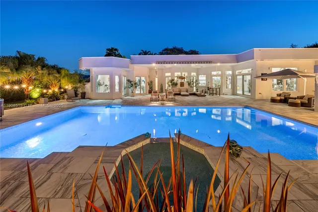 a view of a swimming pool with an outdoor seating