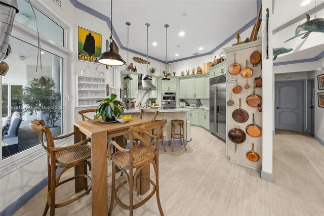 a view of a dining room with furniture and a chandelier