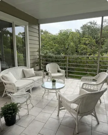a view of a patio with couches table and chairs and potted plants