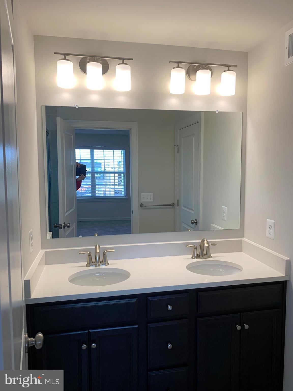 7112 McHenry Mews Frederick, MD 21703 - Photo 15 of 27 a bathroom with a sink and a mirror