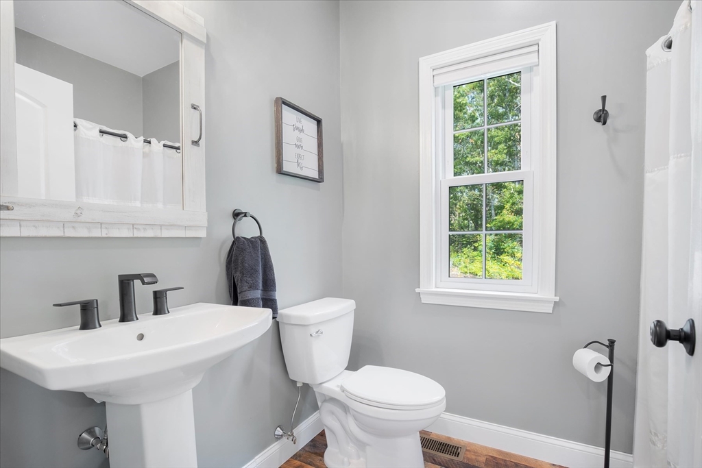 23 Pimlico Pond Road Mashpee, MA 02649 - Photo 12 of 42 a bathroom with a sink a toilet and a window