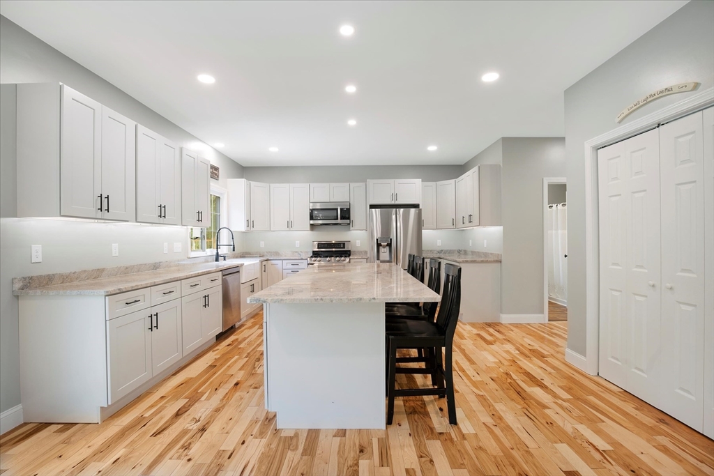 23 Pimlico Pond Road Mashpee, MA 02649 - Photo 14 of 42 a kitchen with refrigerator cabinets and wooden floor