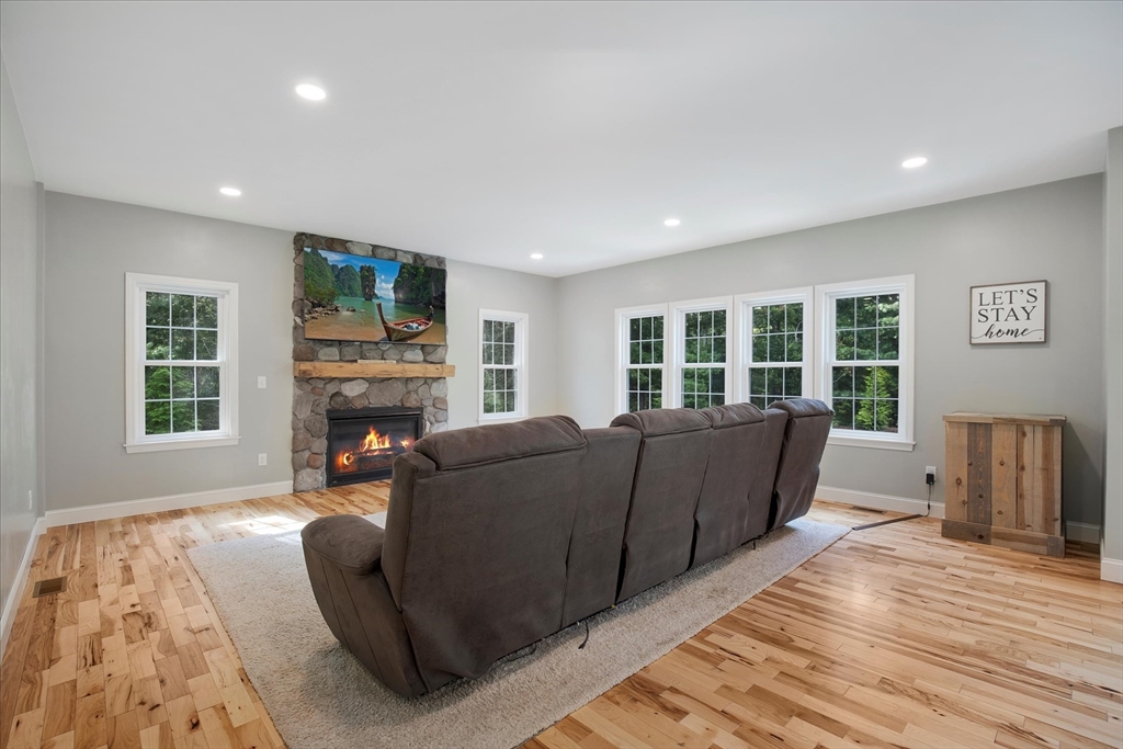 23 Pimlico Pond Road Mashpee, MA 02649 - Photo 16 of 42 a living room with furniture and a fireplace