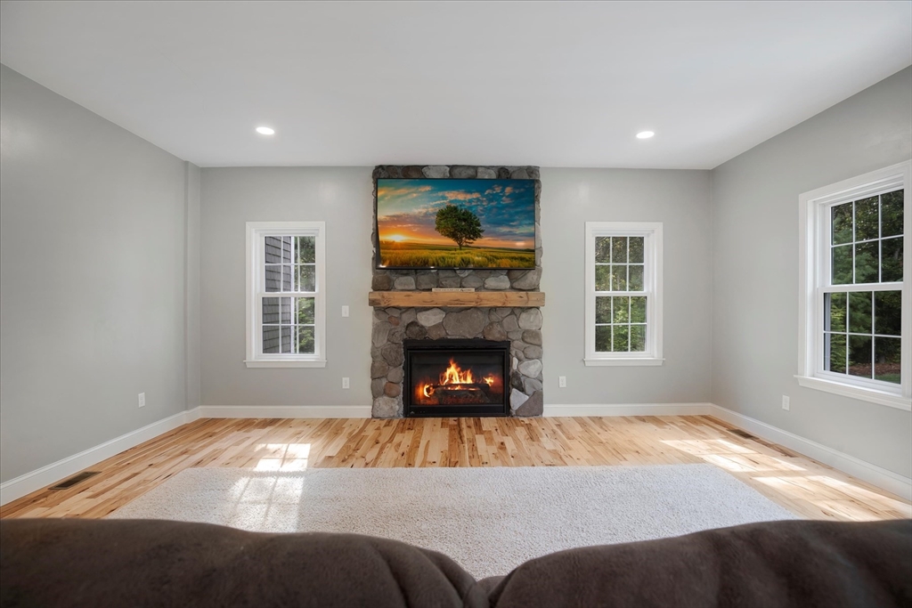 23 Pimlico Pond Road Mashpee, MA 02649 - Photo 17 of 42 a bedroom with a bed and a fireplace