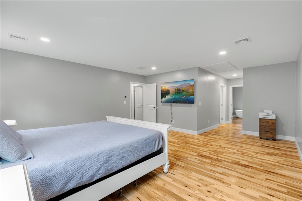 23 Pimlico Pond Road Mashpee, MA 02649 - Photo 24 of 42 a bedroom with a large bed and a flat screen tv