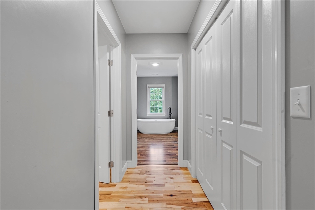 23 Pimlico Pond Road Mashpee, MA 02649 - Photo 25 of 42 a view of a hallway with white walls and wooden door