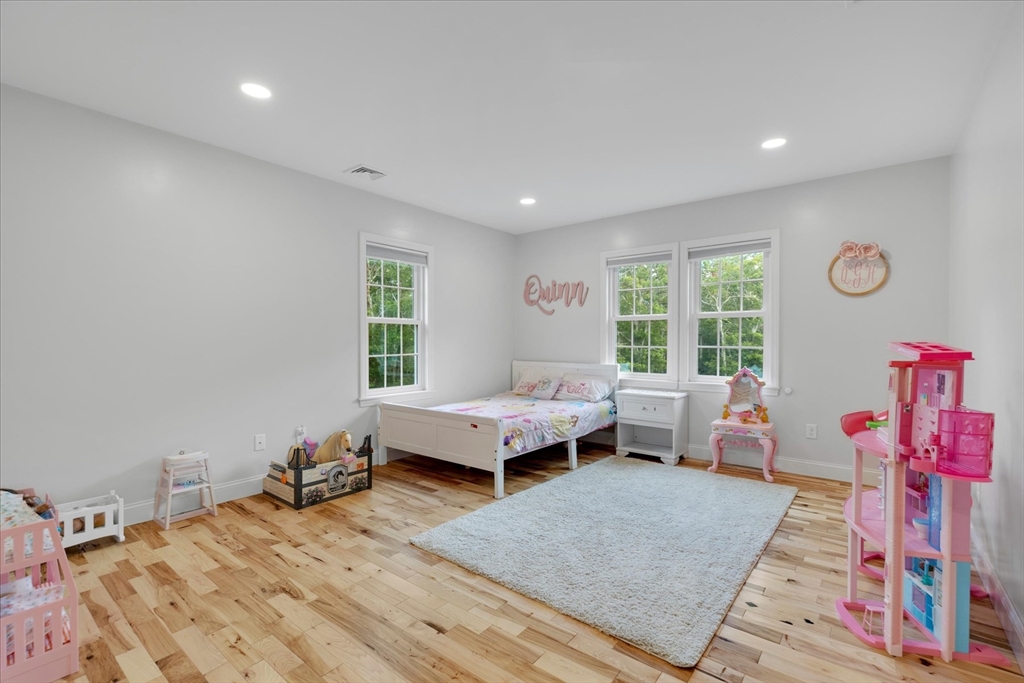 23 Pimlico Pond Road Mashpee, MA 02649 - Photo 30 of 42 a bedroom with a bed and wooden floor