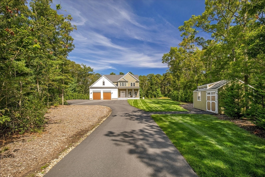 23 Pimlico Pond Road Mashpee, MA 02649 - Photo 3 of 42 a front view of a house with a yard and trees