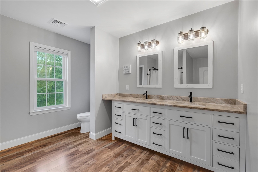 23 Pimlico Pond Road Mashpee, MA 02649 - Photo 33 of 42 a bathroom with a double vanity sink a mirror and a toilet