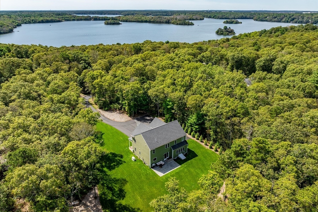 23 Pimlico Pond Road Mashpee, MA 02649 - Photo 4 of 42 an aerial view of a house with a garden and lake view